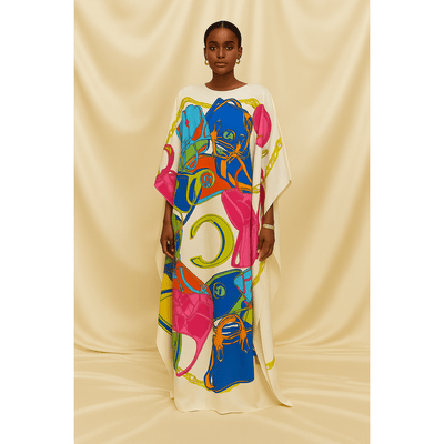 Model wearing multicolor handbag print silk kaftan on ivory background
