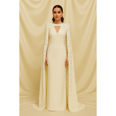 Model in white embellished cape gown with keyhole neckline 